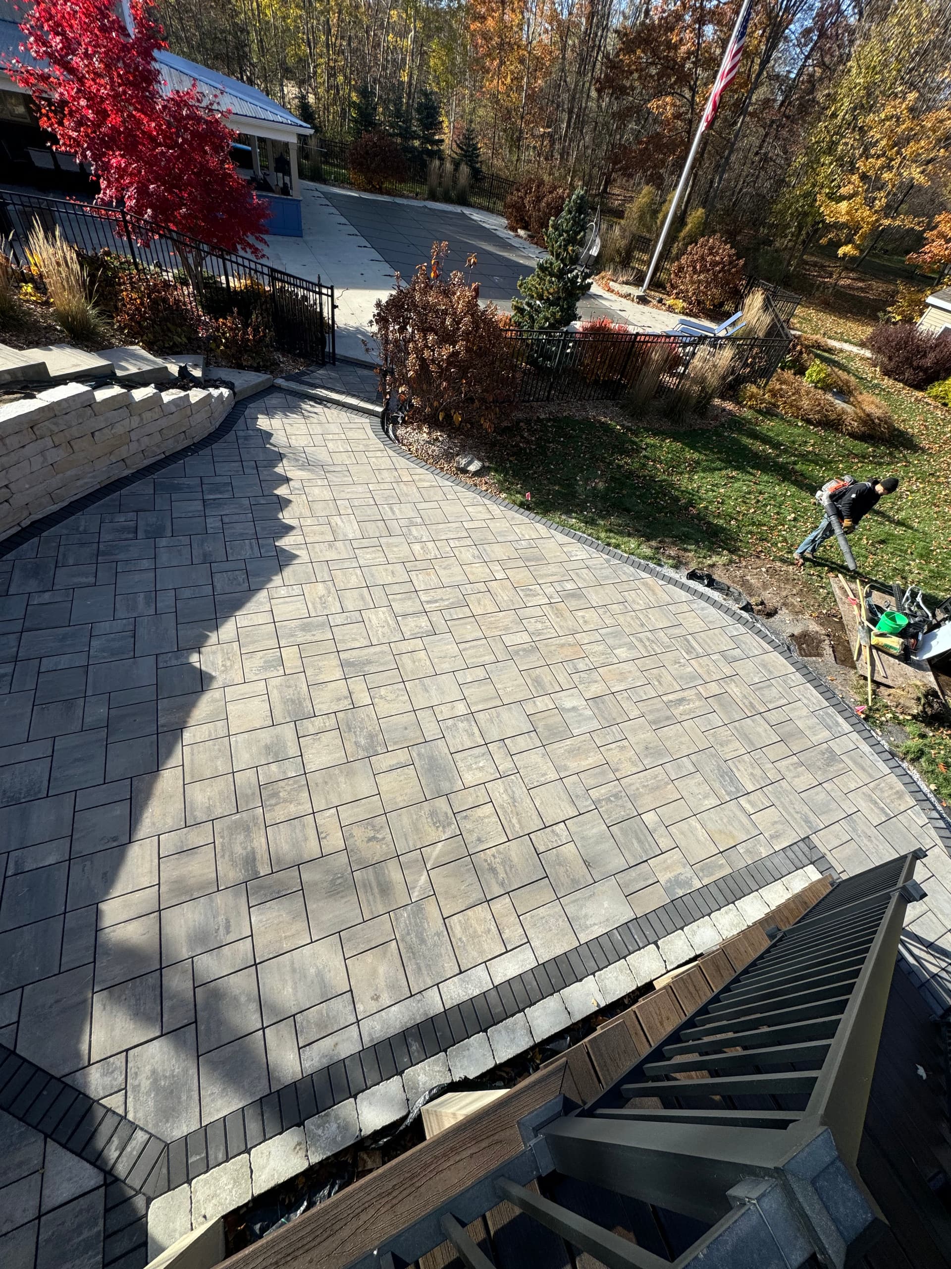 Curved Retaining Wall and Paver Patio Built for Backyard Gatherings