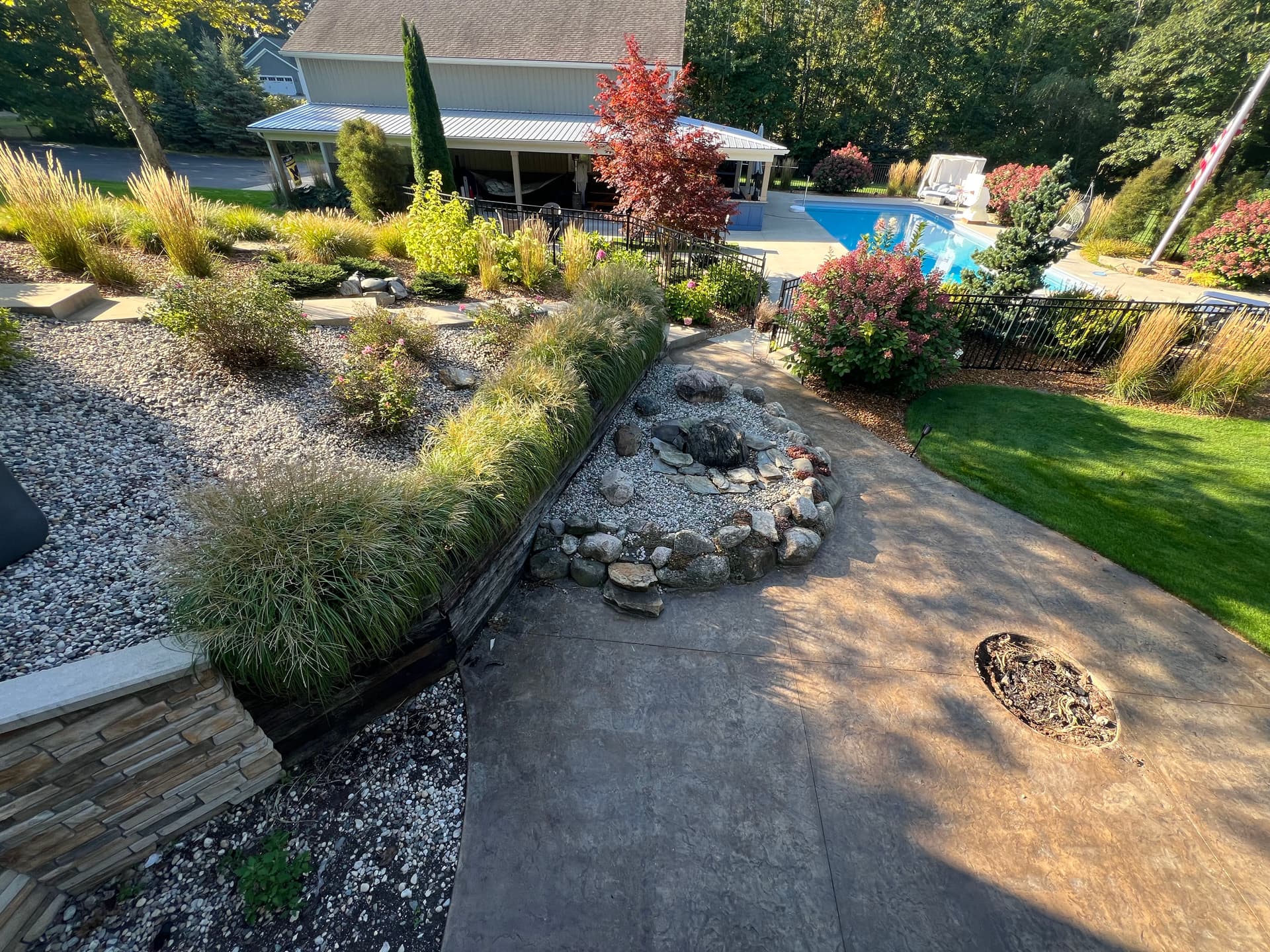 Curved Retaining Wall and Paver Patio Built for Backyard Gatherings